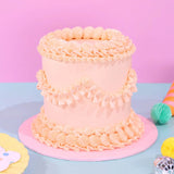 Vintage Cake - Single Colour with hand-piped Swiss Meringue icing and six layers, beautifully decorated by Crumbs & Doilies.